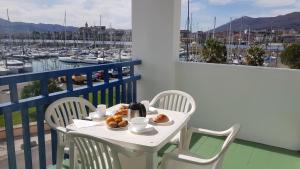 a white table with a plate of food on a balcony at Sokoburu Deluxe Beach in Hendaye +2 photos