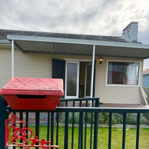 a house with a red bin in front of it at Ferguson House in Cessnock