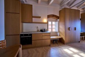 a kitchen with wooden cabinets and a table at Casa Zacco in Parga