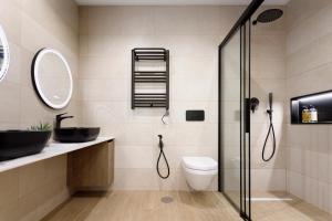 a bathroom with a glass shower and a toilet at REM III Premium Torrevieja in Torrevieja