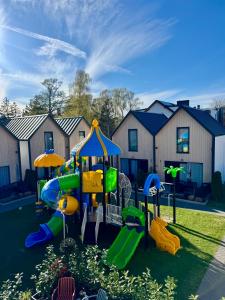 a playground in a yard with houses in the background at Holiday Point in Międzywodzie