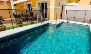 a swimming pool on the roof of a house at Viña-Home in Torre del Mar