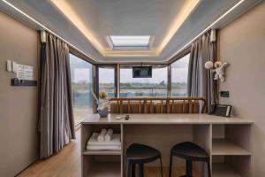 a room with a desk and a large window at Anchaviyo Resort in Vāda