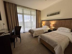 a hotel room with two beds and a desk at Park-Hotel Kidev in Chubynske +115 photos