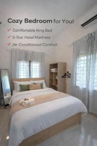 a bedroom with a large bed with white sheets at Lot 766, Langkawi in Pulau Langkawi