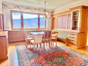 a dining room with a table and chairs at Apartment Karawankenblick with Lake View - Free Parking in Pörtschach am Wörthersee