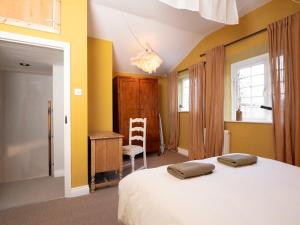 a bedroom with a bed and a desk and a chair at The Old Cookery Cottage & Free Parking in Goldsborough