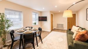 a living room with a table and a couch at Newly Renovated 2-Bed Flat | Ripon Town Centre in Ripon