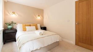 a bedroom with a bed with two towels on it at Newly Renovated 2-Bed Flat | Ripon Town Centre in Ripon +3 photos