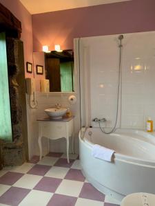 a bathroom with a tub and a sink at Hotel Boutique Villa de Palacios - Palacio de Aras in San Miguel de Aras +87 photos