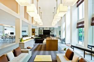 an open living room with white walls and large windows at Element by Marriott Arundel Mills BWI Airport in Hanover