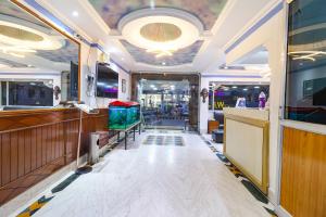 a room with a bar with a counter and a room with at FabHotel Nand's Residency in Patna
