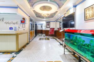 a hallway with a fish tank in a room at FabHotel Nand's Residency in Patna +29 photos
