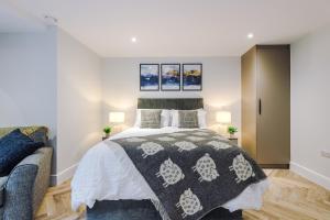 a bedroom with a bed and a couch at Rock Mill - Deluxe Studio Apartment with Balcony in Stony Middleton