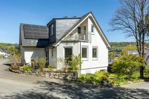 a house with solar panels on the roof at Ferienwohnung Im Tal Olsberg in Olsberg