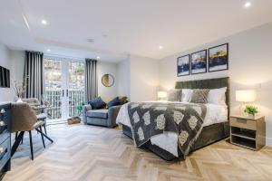 a bedroom with a bed and a living room at Rock Mill - Deluxe Studio Apartment with Balcony in Stony Middleton +35 photos