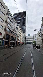 an empty street in a city with tall buildings at Messe-clarastrasse -Wohnung in Basel
