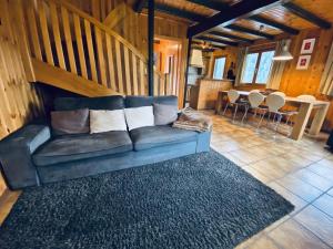 a couch in a living room with a table at Chalet Le Jeuna in Morgins +10 photos