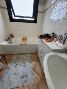 a bathroom with a tub and a sink and a bath tub at Lilas house in Les Lilas +9 photos