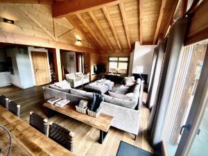 a living room with a couch and a table at Chalet Les Dalton, Morgins in Morgins