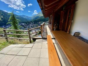 a porch of a house with a view of a mountain at Chalet Les Dalton, Morgins in Morgins