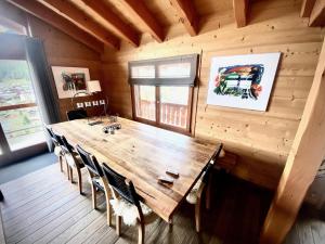 a dining room with a wooden table and chairs at Chalet Les Dalton, Morgins in Morgins