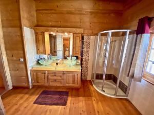 a bathroom with two sinks and a shower at Le Mélézin Bleu in Morgins +12 photos