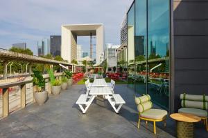 a patio with tables and chairs on a building at citizenM Paris La Défense in Nanterre