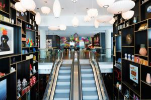 a shopping mall with escalators in a store at citizenM Paris La Défense in Nanterre