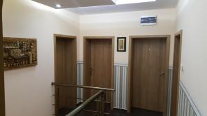 a hallway with three doors and a stair case at Ego Guest House in Belogradchik