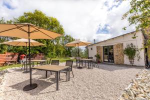 a group of tables with umbrellas in a patio at B&B Villa Pilotti in Penna San Giovanni +68 photos