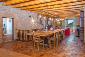 a large dining room with a wooden table and chairs at Can Mas in Fontcuberta