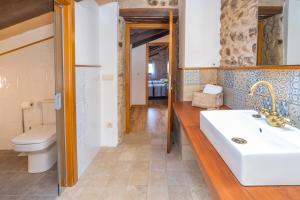 a bathroom with a sink and a toilet at Can Mas in Fontcuberta +33 photos