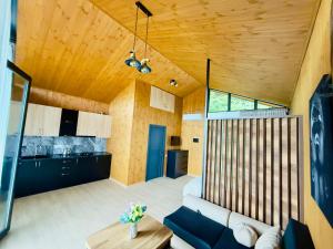 a living room with a couch and a table at Tianuli cottage in Kakhoianebi +12 photos