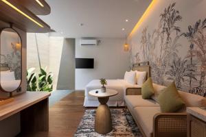a living room with a couch and a table at Solaris Hotel Malang in Malang