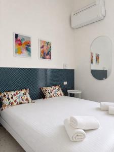 a bedroom with a bed with two towels on it at Dietro le Quinte Rho Apartments in Rho