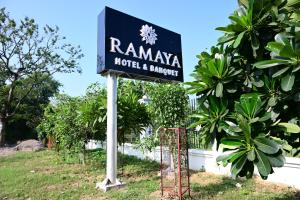 a sign for a hotel and surrounded by trees at Ramaya Hotel & Banquet in Sidhaulī +2 photos