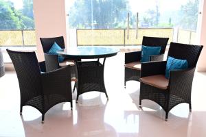 a group of chairs and a table in a room at Ramaya Hotel & Banquet in Sidhaulī