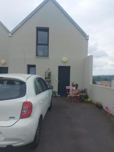 a white car parked in front of a white house at Coutances in Coutances