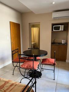 a room with a table and chairs and a microwave at Maison Apart Hotel in Mar del Plata