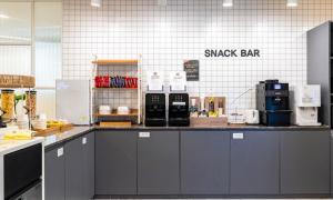 a counter in a kitchen with a snack bar at Daejeon Brown Dot Wolpyeong in Daejeon
