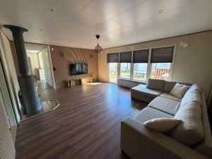 a large living room with a couch and a fireplace at Slottshuset in Borgholm
