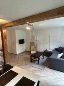 a living room with a couch and a table at Moderne lejlighed ved Flensborg havn in Flensburg
