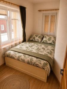 a small bed in a room with a window at Apartmán Eskadra 1 in Horní Malá Úpa