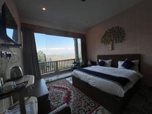 a bedroom with a bed and a balcony with a view at Magnetic Ridge Kasar in Hawālbāgh