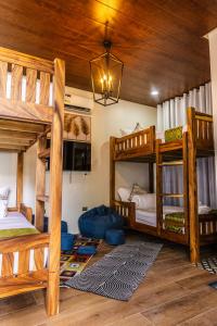 a room with three bunk beds and a chandelier at Uno Maya by Araw Residences in Nasugbu +69 photos