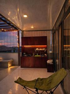 a large bathroom with a bed and a tub at Bareka Hotel in Phú Quốc