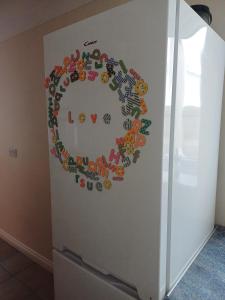 a refrigerator with a circle of vegetables painted on it at Large countryside home in Tow Law