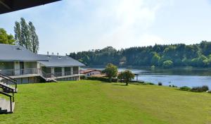 a house on a hill next to a lake at Dunkeld East in Dullstroom