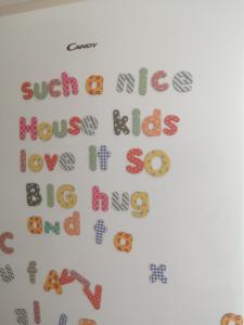 a white refrigerator with alphabet magnets on it at Large countryside home in Tow Law